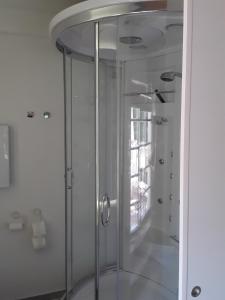 a glass shower in a bathroom with a window at Holzwerk Oybin in Oybin
