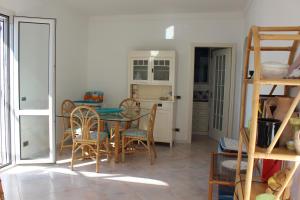 a kitchen and dining room with a table and chairs at Villa Giuliana in Pisciotta