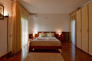 a bedroom with a bed and a large window at Amaranda B&B in Catania