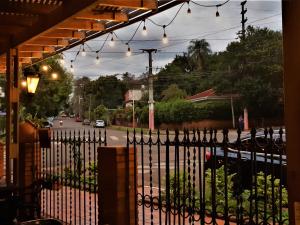 a gate with a wrought iron fence and a street at Cataratas Jazz Hostel in Puerto Iguazú