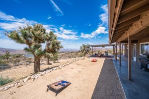 an outdoor patio of a house with a view of the desert at The Full Moon, Joshua Tree: Hot Tub, Sauna, Views in Joshua Tree
