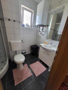 un baño con inodoro y lavabo en Apartman Pati, en Livno 10 fotos más
