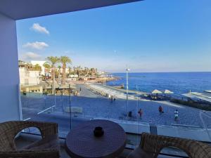 a balcony with a view of a beach and the ocean at COSea Living: Seaside Two Bedroom Flat in Harbour 106 in Paphos City