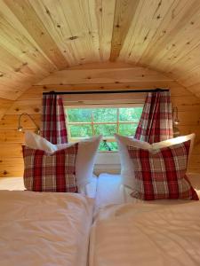 a bed with two pillows and a window in a room at Timmi Lake in Timmendorfer Strand