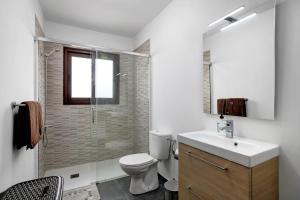 a bathroom with a toilet and a sink and a shower at Casa Micaela 1 in Tacoronte +19 photos