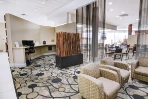 a lobby with chairs and a waiting room with a table at Holiday Inn St. Petersburg N - Clearwater, an IHG Hotel in Clearwater