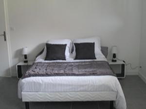 a bedroom with a large bed with two night stands at La Ferme de la Petite Noé in Tracy-sur-Mer