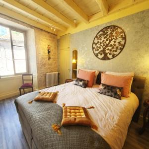 a bedroom with a large bed and a large window at Maison Fossemagne in Melle