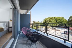 a balcony with two chairs and a view of a street at VM Apartments in Rhodes Town