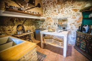 uma cozinha com uma mesa numa cozinha de pedra em Traditional Villa Askyfou em Karés