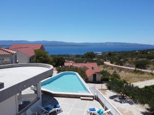 a swimming pool with a view of the water at Villa Franka with swimming pool in Bol