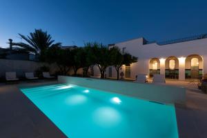 a swimming pool with blue lighting in front of a building at Palazzo Angelica BeB Salento - bed and breakfast Otranto in Giurdignano