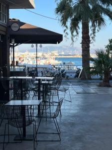 a group of tables and chairs with a view of the water at Kalymnos Gallery in Kalymnos