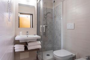 a bathroom with a sink and a toilet and a shower at Hotel Centrale in Mestre