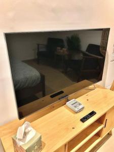 a large flat screen tv sitting on top of a table at Studio Exotique Hyper-Centre Enghien 12min Paris in Enghien-les-Bains