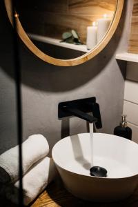 a bathroom with a white sink and a mirror at Les diamants de l'éternel in Saint-David-de-Falardeau