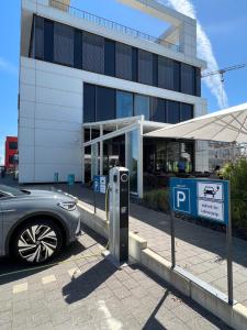 a car parked in front of a building with a parking meter at Toploft The Aparthotel in Crailsheim