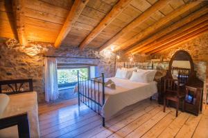 a bedroom with a bed in a room with wooden ceilings at Traditional Villa Askyfou in Karés