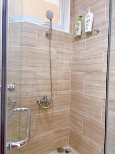 a shower with a glass door in a bathroom at Nice Apartment Oasky Vũng Tàu 1805 in Vung Tau