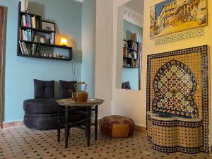 a living room with a table and a couch at Tangier Kasbah Hostel in Tangier