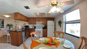 a kitchen with a table and a dining room at Sea Club Condo #12 in Clearwater Beach