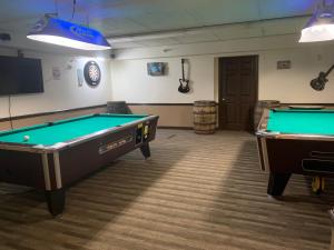 a room with two pool tables and a tv at Americas Best Value Inn & Suites Melbourne in Melbourne