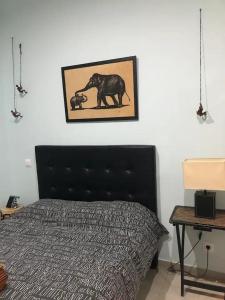 a bedroom with a bed and a picture on the wall at APARTAMENTO PRIVADO CERCA DE IFEMA y AEROPUERTO in Madrid