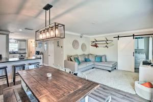 a kitchen and living room with a table and a couch at New Smyrna Beach Townhome, Walk to Bay Access! in New Smyrna Beach