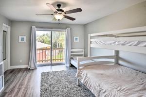 a bedroom with two bunk beds and a ceiling fan at New Smyrna Beach Townhome, Walk to Bay Access! in New Smyrna Beach