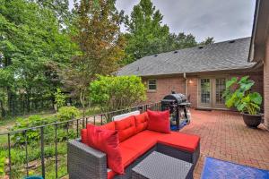 a red couch on a patio in front of a house at Bright Chesapeake Home Near Shopping and Dining in Chesapeake