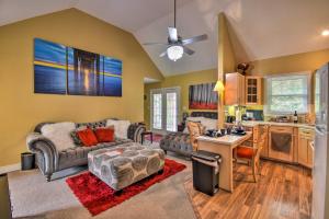 a living room with a couch and a kitchen at Bright Chesapeake Home Near Shopping and Dining in Chesapeake