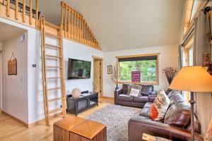 a living room with a couch and a ladder at Waterfront Cabin with 2 Boat Docks and Mtn Views! in Saint Maries
