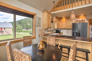 a kitchen with a table and chairs and a refrigerator at Waterfront Cabin with 2 Boat Docks and Mtn Views! in Saint Maries