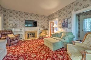 a living room with a couch and a fireplace at Coastal Grand - Walk to Lake Michigan! in Ludington