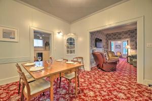 a dining room with a table and chairs and a living room at Coastal Grand - Walk to Lake Michigan! in Ludington