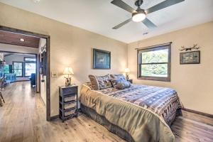 a bedroom with a bed and a ceiling fan at Quiet Lakeside Cabin Patio and Stunning Views! in Grantsburg