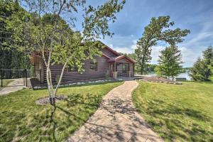 a path leading to a log cabin at Quiet Lakeside Cabin Patio and Stunning Views! in Grantsburg