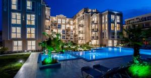 a large building with a swimming pool in front of it at Apartments Vilma&Villiam in Ravda