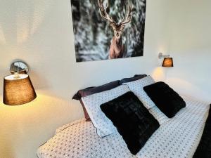 a bedroom with a bed with a deer picture on the wall at Saas-Fee renovated flat in center of the village in Saas-Fee