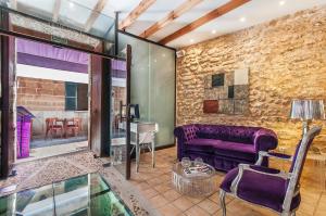 a living room with a purple couch and a table at Ca´n Pere in Alcudia