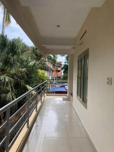 a balcony with a view of a swimming pool at Sandy beach hotel in Trivandrum