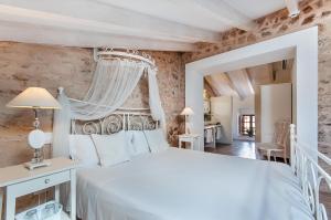 a bedroom with a white bed and a window at Ca´n Pere in Alcudia