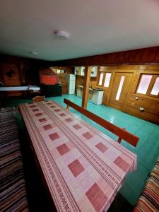a bedroom with a large bed and a table at Casa Delia in Slănic-Moldova +11 photos