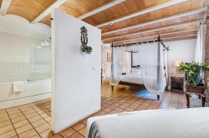 a bedroom with a bed and a tub in a room at Ca´n Pere in Alcudia