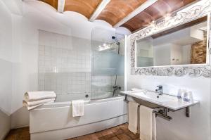a white bathroom with a tub and a sink at Ca´n Pere in Alcudia