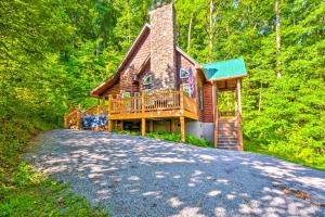 a log cabin in the woods with a driveway at Serene Smoky Mountains Cabin Near Chatuge Lake in Hayesville