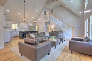 a living room with two couches and a kitchen at Rough River Lake House with Dual Primary Suites! in Fentress McMahan