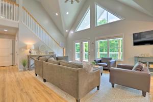 a living room with couches and a skylight at Rough River Lake House with Dual Primary Suites! in Fentress McMahan