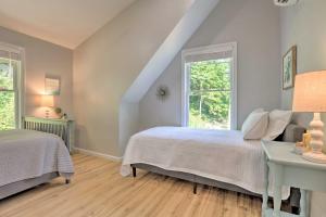 a bedroom with two beds and a window at Rough River Lake House with Dual Primary Suites! in Fentress McMahan