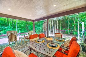 a screened in porch with a table and chairs at Cozy Whitehall Hideaway with Hot Tub and Chiminea! in Whitehall